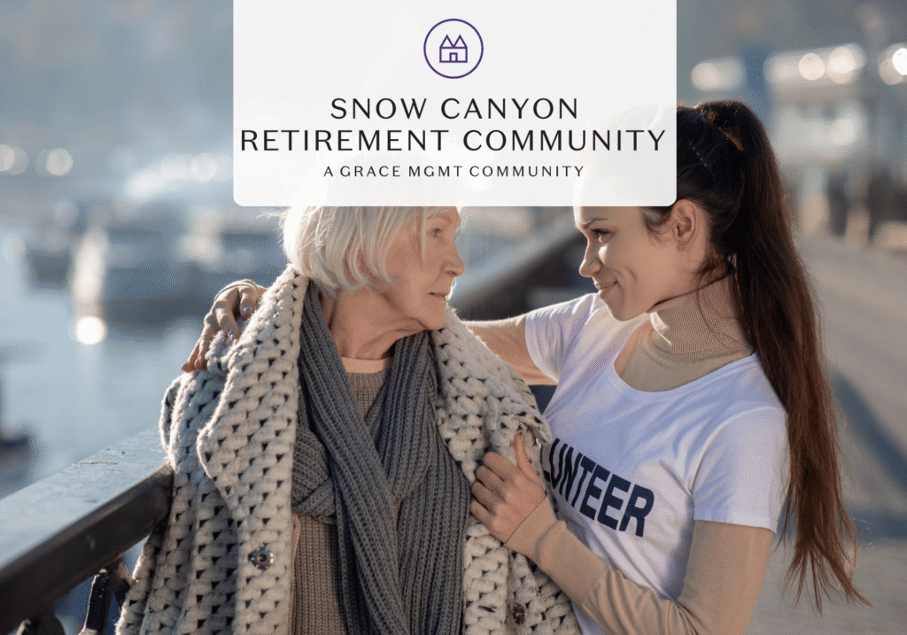 Volunteer companion comforting an elderly woman outdoors by the water, with a Snow Canyon Retirement Community banner above.