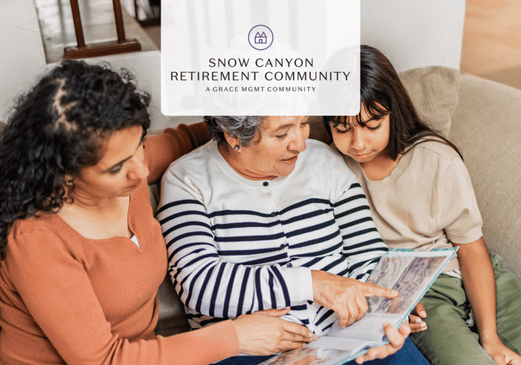 Three people sit on a couch looking at a magazine together, with the Snow Canyon Retirement Community logo overlay above them.