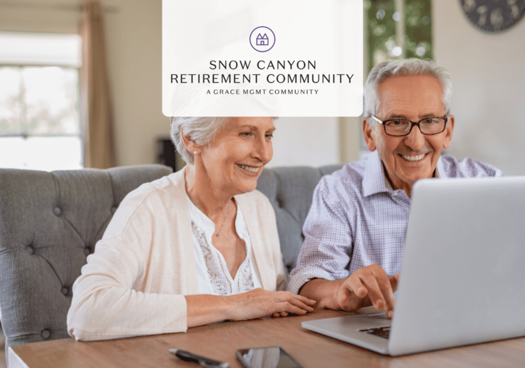 An elderly couple sits at a table with a laptop, smiling as they use it together, with the Snow Canyon Retirement Community logo overlay.